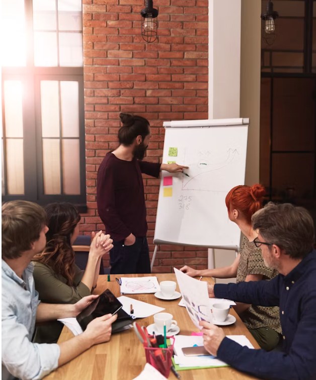 A consultation session where a plan is talked through on a flip chart, the kind of plain-English walkthrough every Alpha Presence project starts with